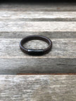 Brown leather bracelet on a wooden surface