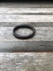 Black leather bracelet on a wooden surface