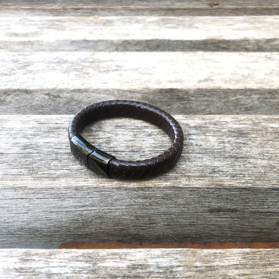 Brown leather bracelet on a wooden surface