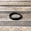 Black leather bracelet on a wooden surface
