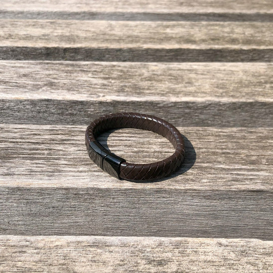 Brown leather bracelet on a wooden surface