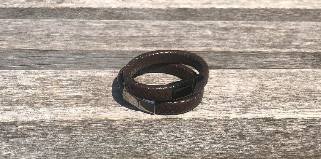 Brown leather bracelet on a wooden surface