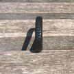Black woven bracelet on a wooden surface