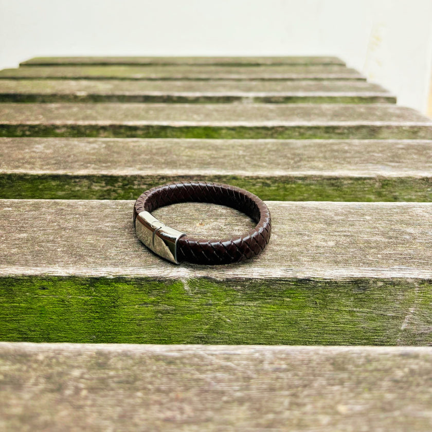 Men’s brown braided leather bracelet with polished stainless steel clasp angled view