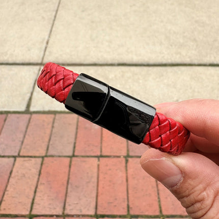 Men’s red braided leather bracelet held in hand