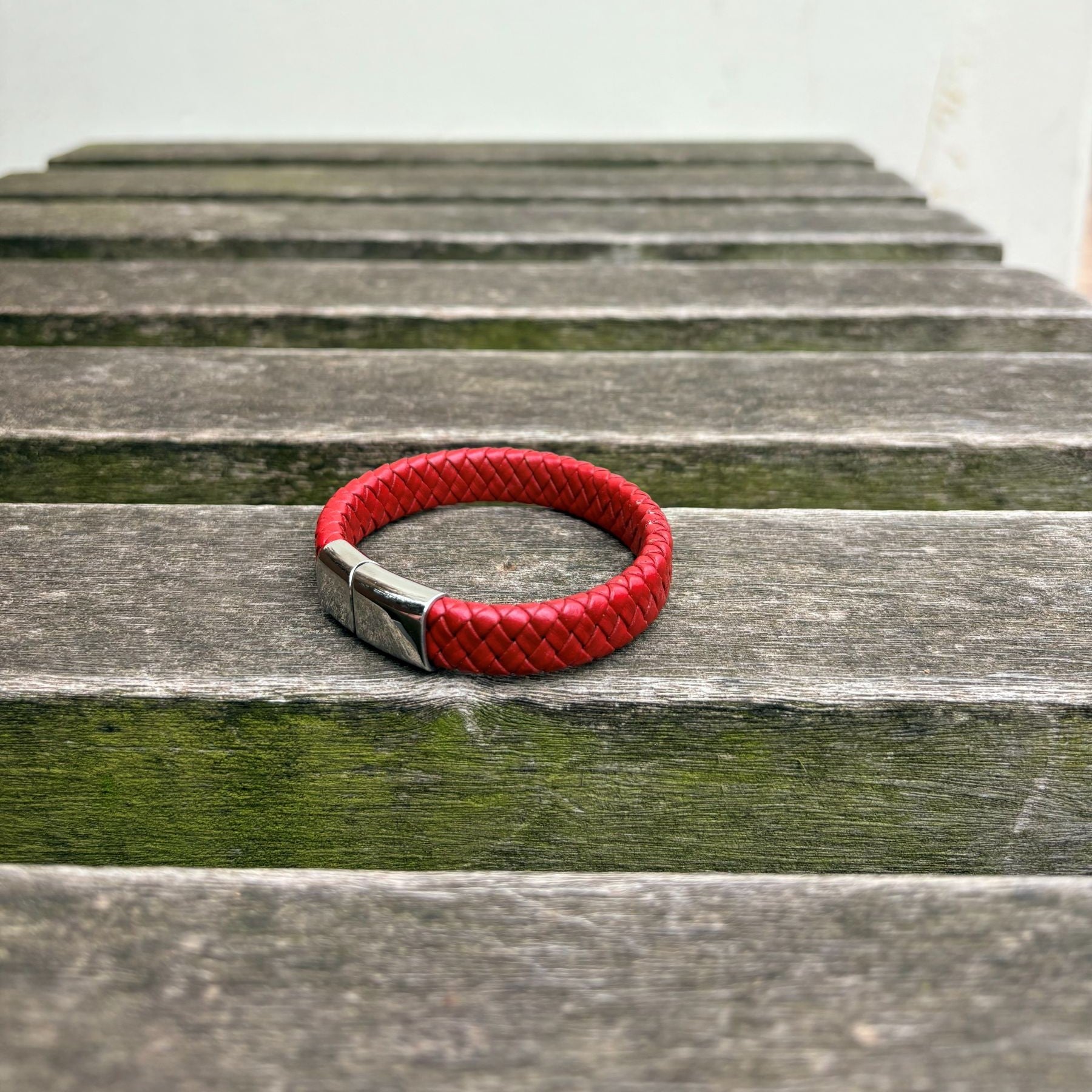 Men’s red braided leather bracelet with polished stainless steel clasp angled view