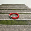 Men’s red braided leather bracelet with polished stainless steel clasp angled view
