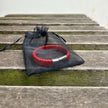 Men’s red braided leather bracelet in drawstring bag packaging