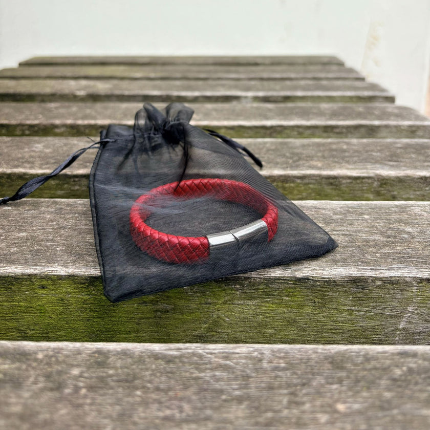 Men’s red braided leather bracelet in drawstring bag packaging