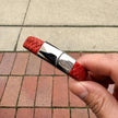 Men’s red braided leather bracelet held in hand